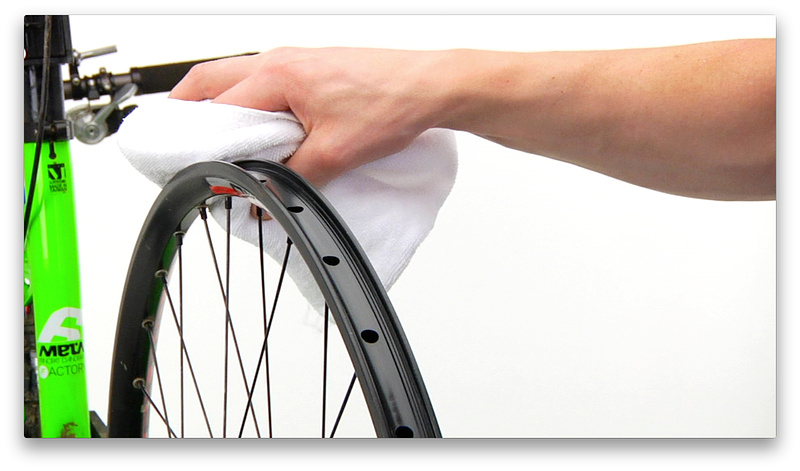 43 second mark - With wheel in bike or stand to hold it in place, clean rim thoroughly so the rim tape has the best possible chance of creating an airtight seal