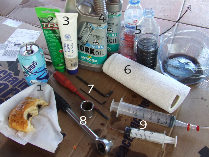 <span style='font-size:19px'>What's needed:</span> <br><br>1. Eat, drink, and take your time - no hurries, especially if it is your first time doing this<br>2. Grease for general use - use on main spring, negative spring, and the spring's detent<br>3. Thin suspension grease - used on bushings, oil seals etc...<br>4. Suspension oil - 5W for the damper and the RockShox recommended 15W for lubrication<br>5. Plastic bottle or any other containers are always useful to pour used oil into. Reuse first, then recycle<br>6. Paper towel or rag<br>7. 5mm and 2mm hex keys - 2mm for removing the compression cover (<I>model 318, the 302 does not have</I>) and the 5mm to loosen the foot bolts<br>8. 24mm socket and ratchet wrench<br>9. Syringes measuring cup to measure the oil volume (<I>15ml in each leg for lube, 200ml in damper</I>)<br> Hammer or rubber mallet