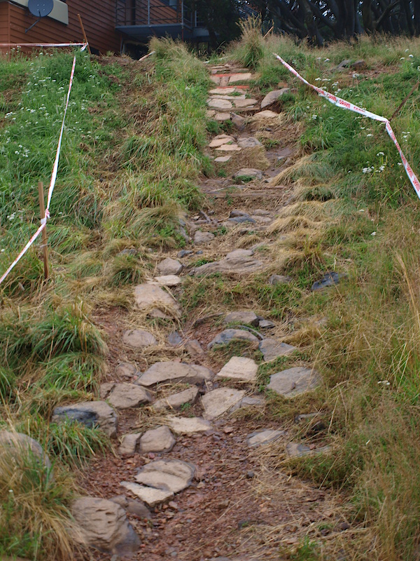 Leaving the start gate, the riders cross under the chairlift and turn a flat right hander into the first chute on the track. This is looking from the base up.