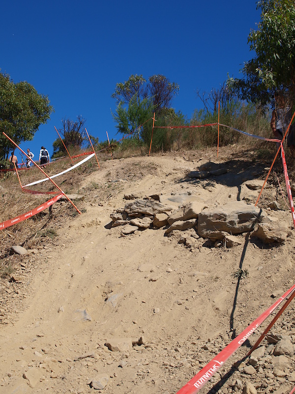 As riders come down the face of the hill these rocks break up the track. Currently they are low enough to roll over but as the track wears this may no longer be the case. The obvious question is why not just drop/jump off them? Answer; You're already coming in with good pace and just after this feature is a right hander followed by a left hander.