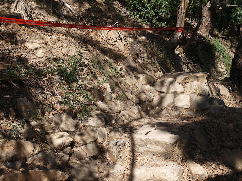 This is a jump where riders land on a set of rock steps. What is not evident in the photo, is that a few riders actually jump up into the side of the hill and wall ride along before dropping back down onto the track.