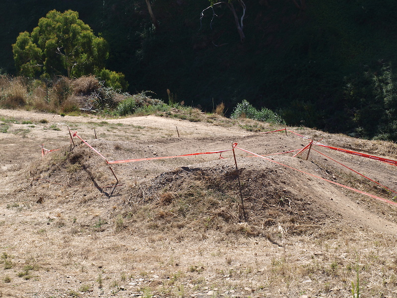 Once riders land this largish double they must turn tight right across a flat slippery corner.