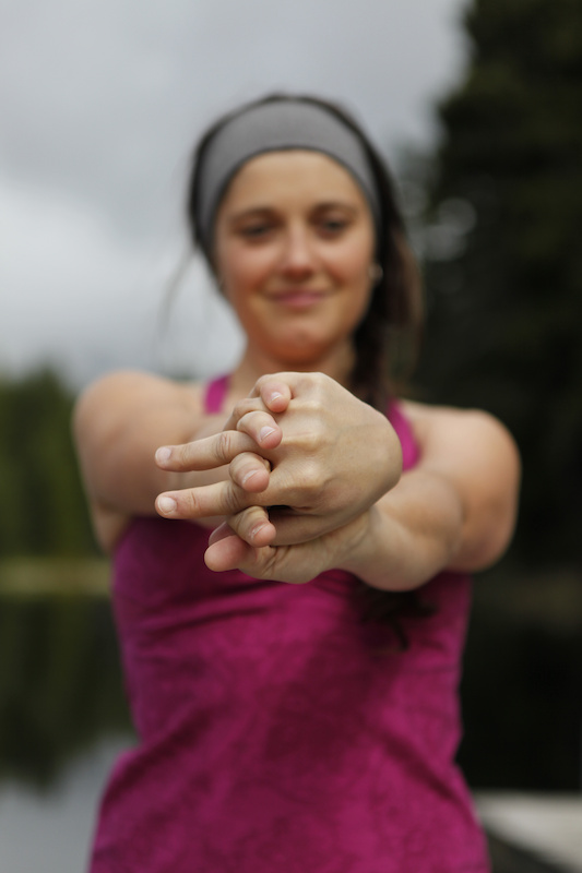 Super important to stretch the forearms after a long ride. Keep the shoulders down and note Yarrow's thumb position, facing downwards. Make sure to do both sides.