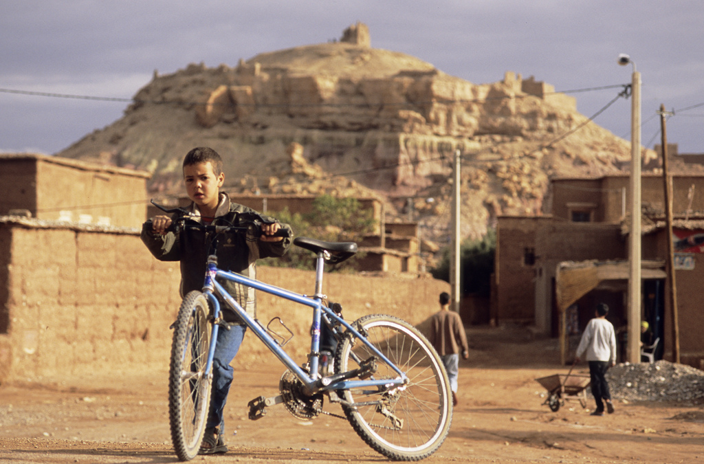 <span style='font-size:12px'>Hitting the plains near Ouarzazate we came across bikes -cheap, oversize Chinese made machines that are too heavy. The local kids don't care about weight though. To a kid, a bike is a bike, anywhere. That's the beauty of them.</span><br><br> It's not your usual way to undertake a bike test, but an understandably common one nonetheless. Reaching forward with leathery, dirt-engrained fingers, the man taps the downtube of my Commencal and smiles with crooked teeth at the resoundingly solid 'ting' that echoes down through its frame. 'Ah, good, good' he says before going on to perform the same quality-assessment on Guillaume's Specialized Enduro and then Mike's Stumpjumper. In a fleeting moment, inside a Marrakech bus station while enveloped by diesel fumes and the noisy revving of overworked engines, the test is complete and my bike is awarded the title of