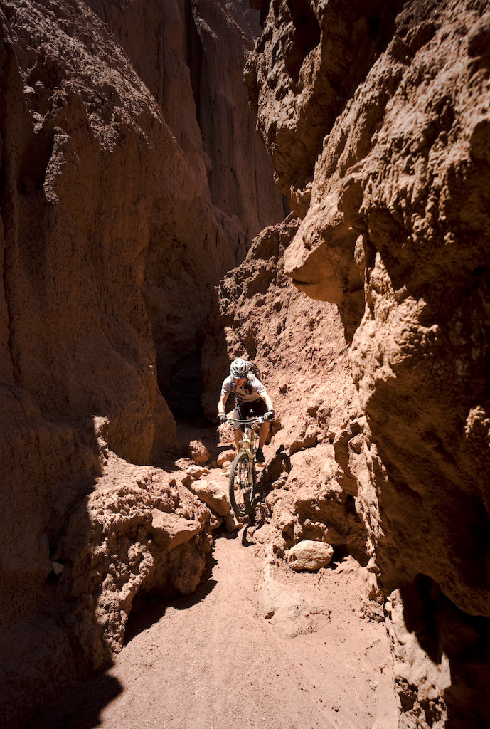 <span style='font-size:12px'>When the dry river beds closed in on us, the riding just became more fun, following tight snaking gorges until they closed out completely. When they did, we about turned and flowed the descent back to the car, loaded up and headed for the next one a few kilometers along the highway. Just don't try this in the rainy season.</span><br><br>Having survived the altitude and cacti, we head south to the red rock hills around Cafayate, punishing our rental car for a few hours down the notoriously rough Ruta 40 to get there. Cafayate itself is a town that has embraced the bike: everyone is riding bikes, everywhere. A guy passes us steering his bike with one hand while balancing a large round cake with the other and the town's school gates are engulfed with parents doing the school run not in cars, but on bikes. Enquiries about mountain biking however yield the same raised eyebrows and blank looks. We turn back to our pirate map and decide to go and explore a dotted line marked on it some ten miles out of town that we hope might equate to a decent ride.