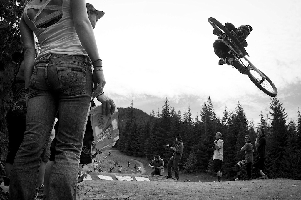 With many of the best downhill and freeride dudes on the planet in Whistler, Sven Martin (Vital) along with SRAM spearheaded the first Unofficial Sick Whip World Championships.  Held the afternoon before the Red Bull Joyride, throngs of people flocked to the recently rebuilt and massive Crabapple Hits. How could anyone resist watching the guys and one gal (Lorraine Blancher) huck their meat and swing the back end of their bike around. It was mayhem as riders trained into the jumps and gave it their all to impress the crowd. Their were signs, there was some booze (we do not condone drinking on the mountain), there was cheering, there were crashes, and in an hour and a half there were more stylish whips showcased than the average person will see in a year. It turned out to be one of the most entertaining afternoons of the week.